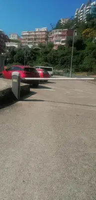 a red car is driving down a street at Marko Apartmani in Budva