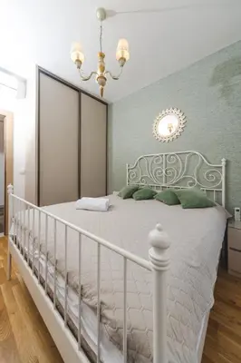 a bedroom with a white bed and a chandelier at Nest 1 in Becici