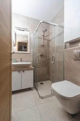 a bathroom with a shower and a toilet and a sink at Nest 1 in Becici