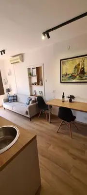 a living room with a couch and a table at Orlic Apartman in Budva