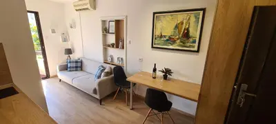 a living room with a table and a couch at Orlic Apartman in Budva
