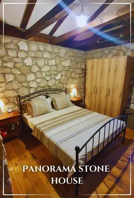 a bedroom with a bed in a stone house at Panorama Stone Houses - Skadar Lake in Cetinje