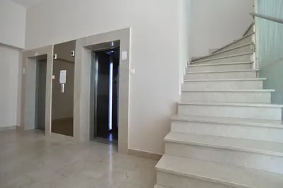 a hallway with stairs and a door in a building at Luxury apart with 3 bedrooms in hotel near the beach in Budva