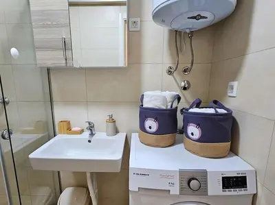 a small bathroom with a sink and a toilet at Blanc 1664 in Podgorica