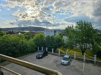 two cars are parked in a parking lot at Blanc 1664 in Podgorica
