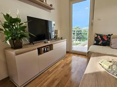 a living room with a large flat screen tv at Blanc 1664 in Podgorica