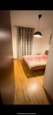 a bedroom with a bed and a window with curtains at Aida apartment City kvart in Podgorica