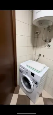 a washing machine in a bathroom with a sink at Aida apartment City kvart in Podgorica