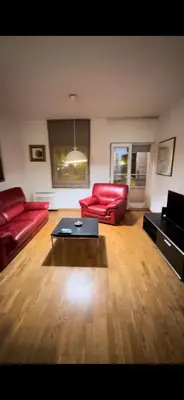 a living room with red couches and a coffee table at Aida apartment City kvart in Podgorica