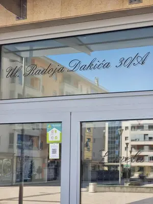 a sign on the window of a store at Aida apartment City kvart in Podgorica