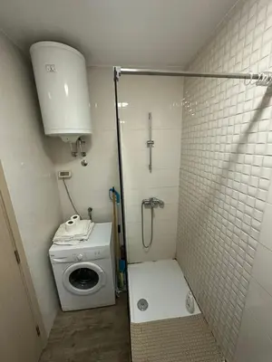 a small bathroom with a shower and a toilet at Marija apartment City kvart in Podgorica