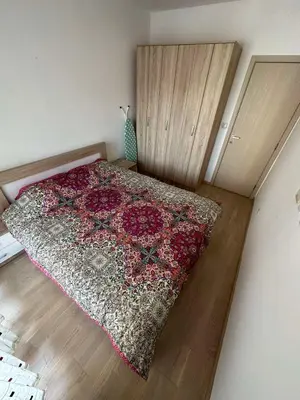 a bedroom with a bed with a rug on the floor at Marija apartment City kvart in Podgorica