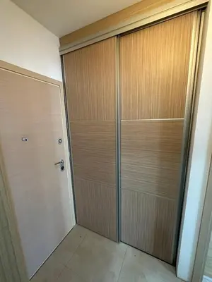 a large closet with wooden doors in a room at Marija apartment City kvart in Podgorica