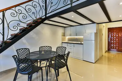 a kitchen and dining room with a table and chairs at SS Studio Oaza mira in Bar, Susanj