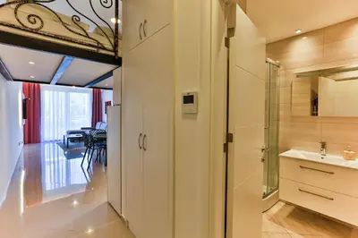 a kitchen with a sink and a glass door at SS Studio Oaza mira in Bar, Susanj