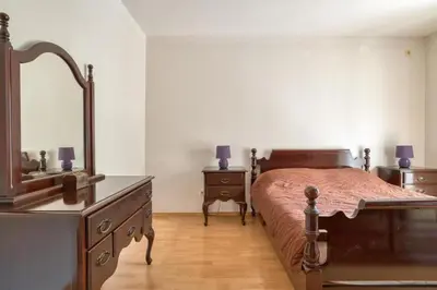a bedroom with a bed and a dresser and a mirror at Underhill Royal View in Kotor