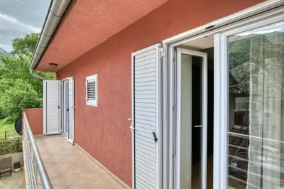 a balcony of a house with a red wall at Underhill Royal View in Kotor
