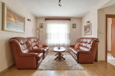 a living room with two leather chairs and a table at Underhill Royal View in Kotor