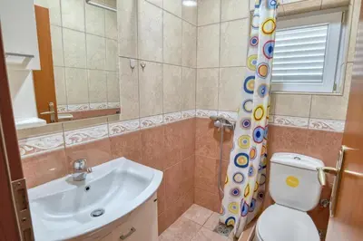a bathroom with a sink and a toilet and a shower at Underhill Royal View in Kotor