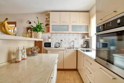 a kitchen with white cabinets and a counter top at Underhill Royal View in Kotor