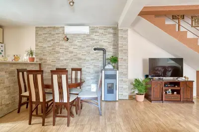 a living room with a table and chairs and a tv at Underhill Royal View in Kotor