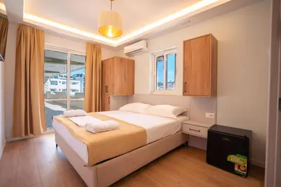 a bedroom with a large bed and a window at Illyria Hotel in Ulcinj