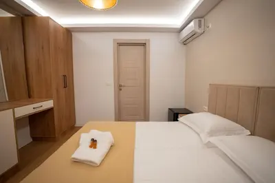 a bedroom with a bed with a towel on it at Illyria Hotel in Ulcinj