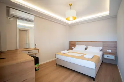a bedroom with a bed and a sink in it at Illyria Hotel in Ulcinj