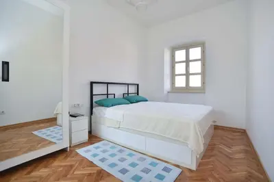 a white bedroom with a large bed and a window at PERFECT OLD TOWN SPOT in Budva in Budva