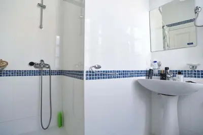a white bathroom with a sink and a shower at PERFECT OLD TOWN SPOT in Budva in Budva