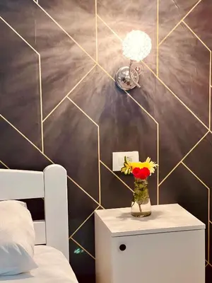 a bedroom with a table with a vase of flowers at Dado in Virpazar