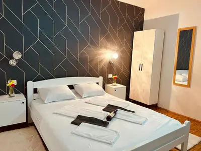 a bedroom with a white bed with towels on it at Dado in Virpazar
