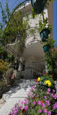 a garden with flowers in front of a building at Dado in Virpazar