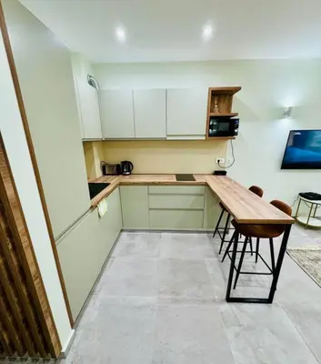 a kitchen with a wooden table and chairs in it at Sea Glass Kotor Bay in Škaljari