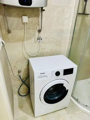 a washing machine in the corner of a bathroom at Sea Glass Kotor Bay in Škaljari
