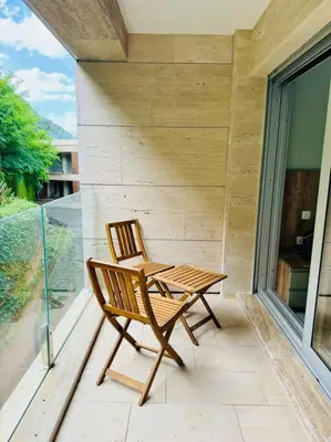 a wooden chair and table on a balcony at Sea Glass Kotor Bay in Škaljari