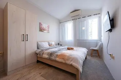a bedroom with a bed and a tv in it at Podgorica City Centre in Podgorica