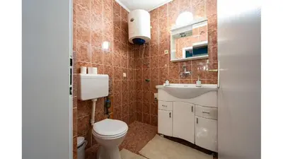 a bathroom with a toilet and a sink at Podgorica City Centre in Podgorica
