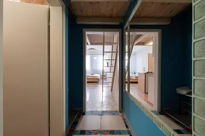 a room with blue walls and a hallway with a mirror at Podgorica City Centre in Podgorica