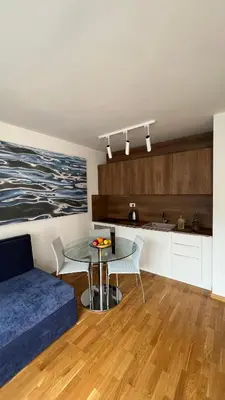 a living room with a table and a kitchen at Four Views By The Sea Apartments in Budva