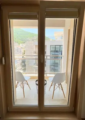 a view from a window of a balcony with chairs at Four Views By The Sea Apartments in Budva