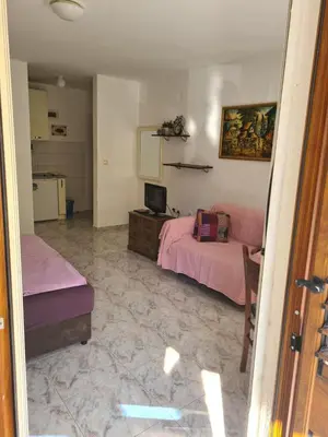 a bedroom with two beds and a desk with a computer at Apartman Zvjezdana Dolina in Budva