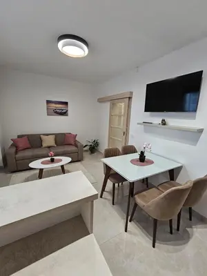 a living room with a couch and tables and a tv at Kristina lux apartment in Bar
