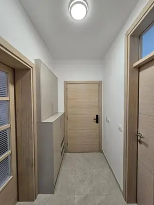 an empty hallway with a door and a kitchen at Kristina lux apartment in Bar