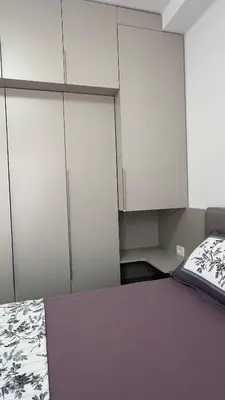 a bedroom with white cupboards and a bed at Kristina lux apartment in Bar
