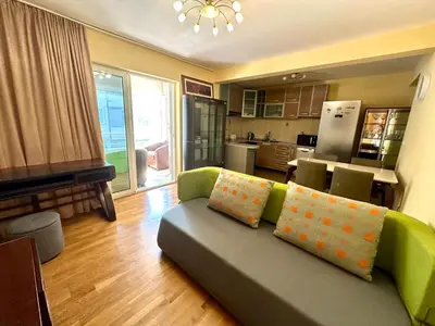 a living room with a couch and a kitchen at Apple apartment Petrovac in Petrovac na Moru
