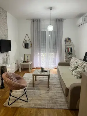 a living room with a couch and a coffee table at Renta Slatki kutak in Podgorica