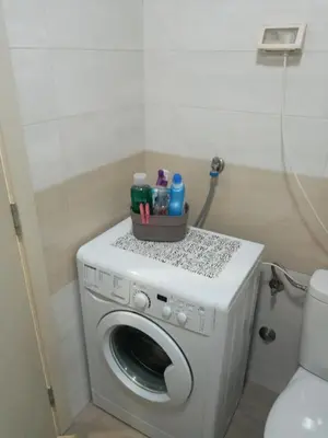 a washing machine with a basket on top of it at Renta Slatki kutak in Podgorica