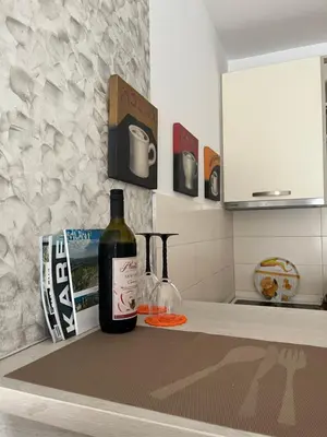 a bottle of wine sitting on top of a kitchen counter at Renta Slatki kutak in Podgorica