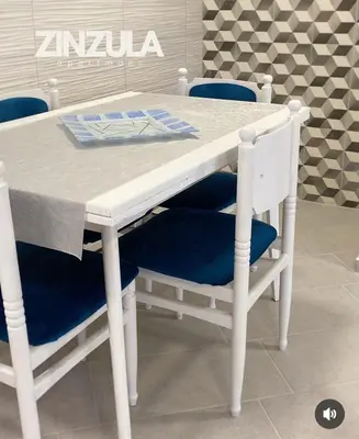 a white table with two blue chairs and a table with a table at Zinzula 2 in Bar